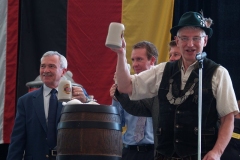 Mayor Tom Henry taps the first keg