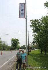 Chuck and Heidy Kiess under the newly installed banner