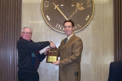 2008/12/16: Smith presents Didier with plaque commemorating his first year as President
