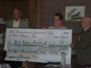 Downtown Optimist Club President Ruth Hammer and Downtown Optimist Club Member Melvin Schott present $40,000 check to Parks & Recreation Director Al Moll at October 4th Optimist Club meeting.